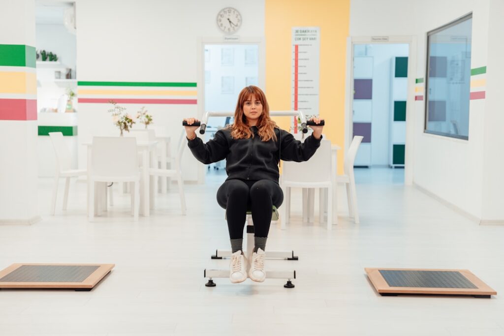 a woman sitting on top of a machine in a room